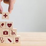 Hand arranging wood block stacking with icon healthcare medical, Insurance for your health concept